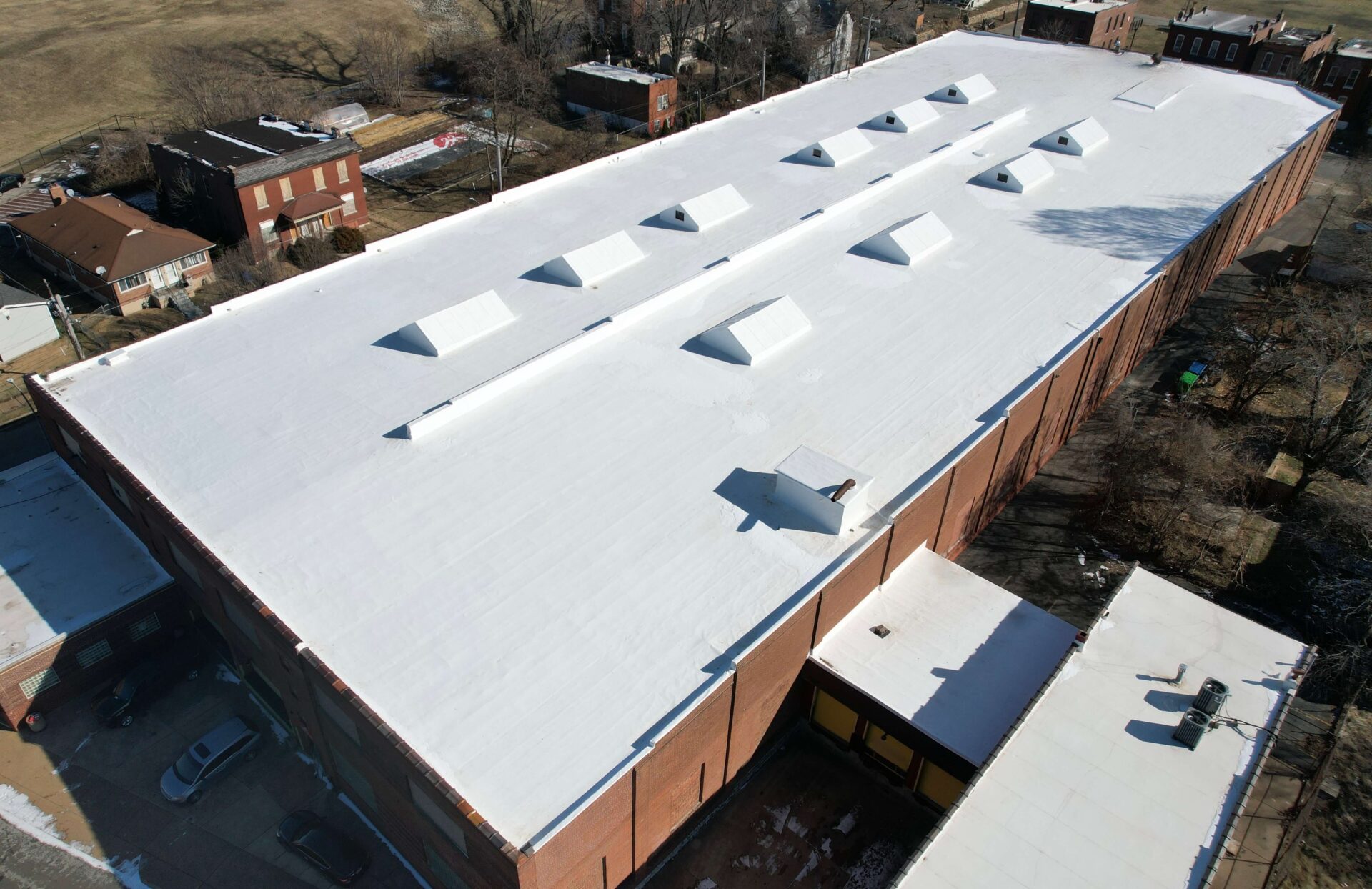 A top-down view of a commercial single-ply roofing system on a large commercial building