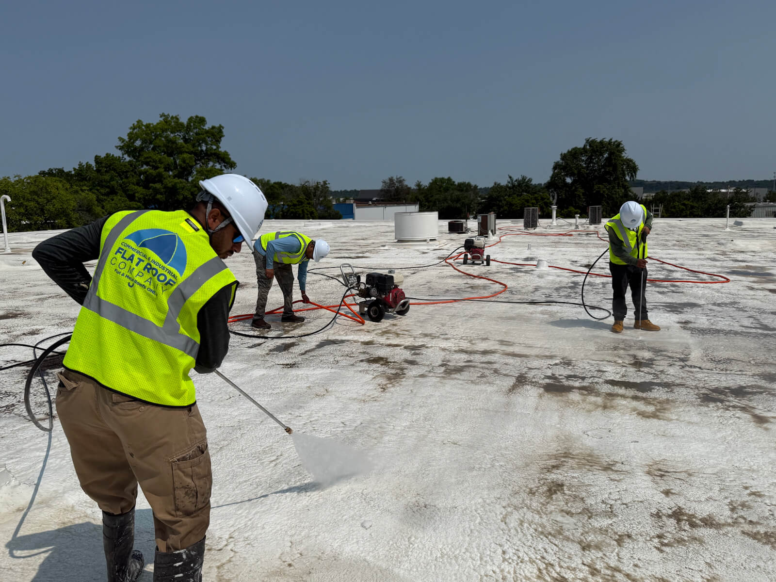 A roofer applies a protective coating to restore a roof