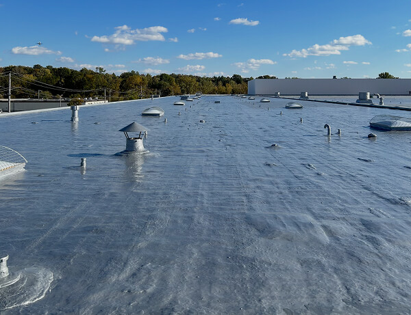 A polyurethane roof coating protecting a flat commercial roofing system