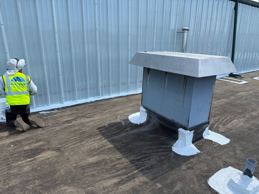 commercial-roof-repair-flashing-detail-99 Commercial roof repair showing flashing and penetration sealing on a flat roof