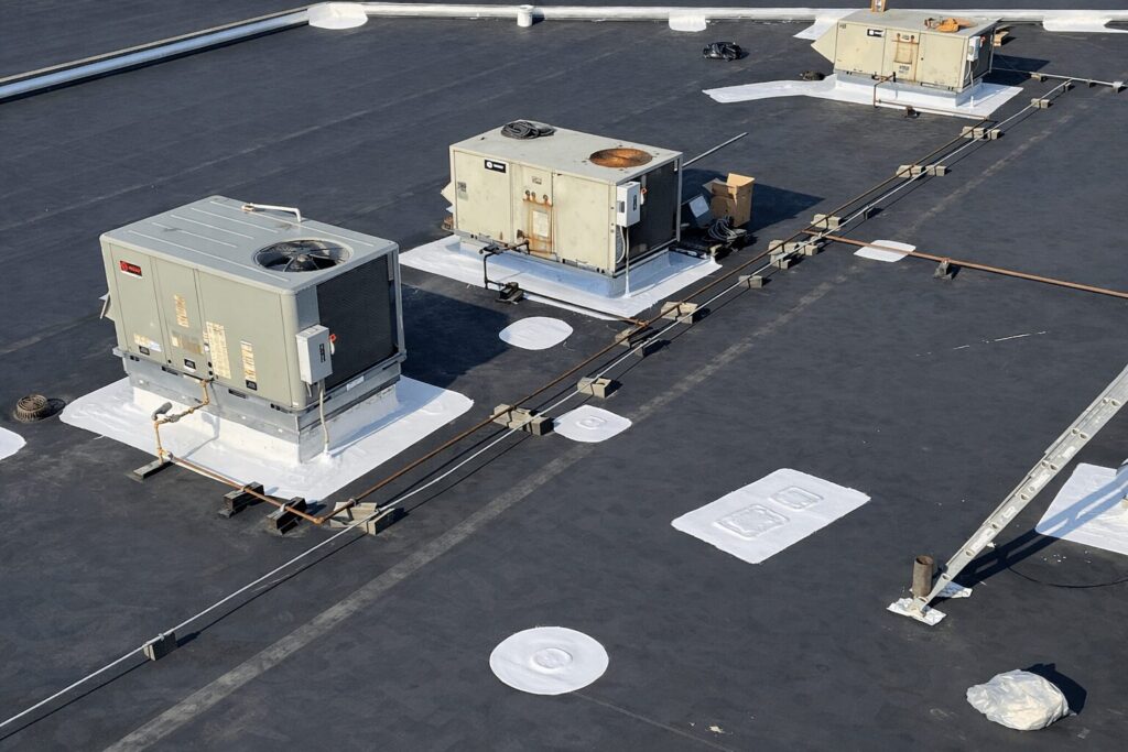 Aerial view of industrial building requiring commercial roof repair after winter