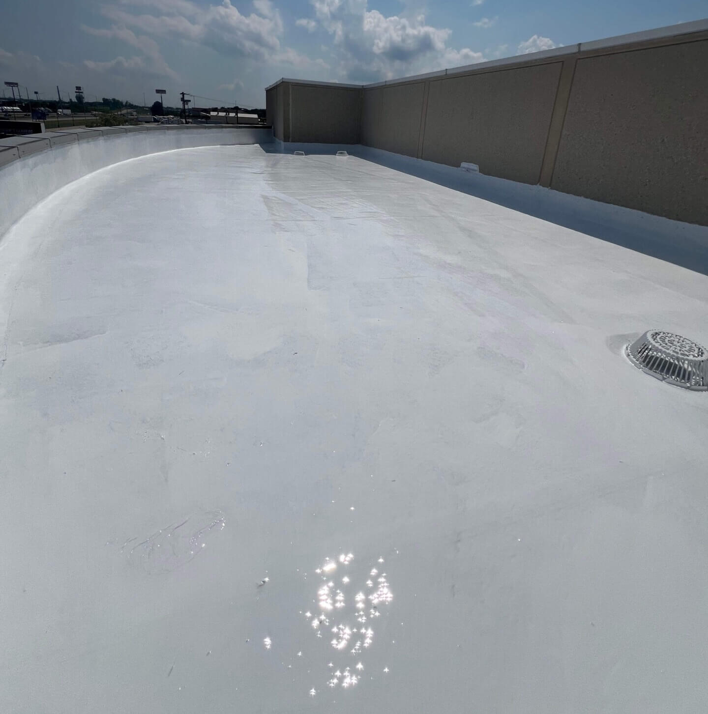commercial-silicone-roof-coating-application-99 Silicone roof coating being applied to a commercial flat roofing system for waterproofing and restoration