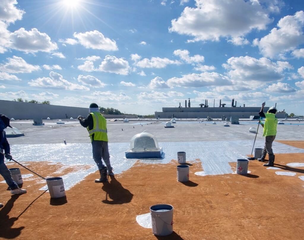 silicone-roof-coating-commercial-building-99-2 Silicone roof coating installed on commercial flat roof to improve waterproofing and UV protection