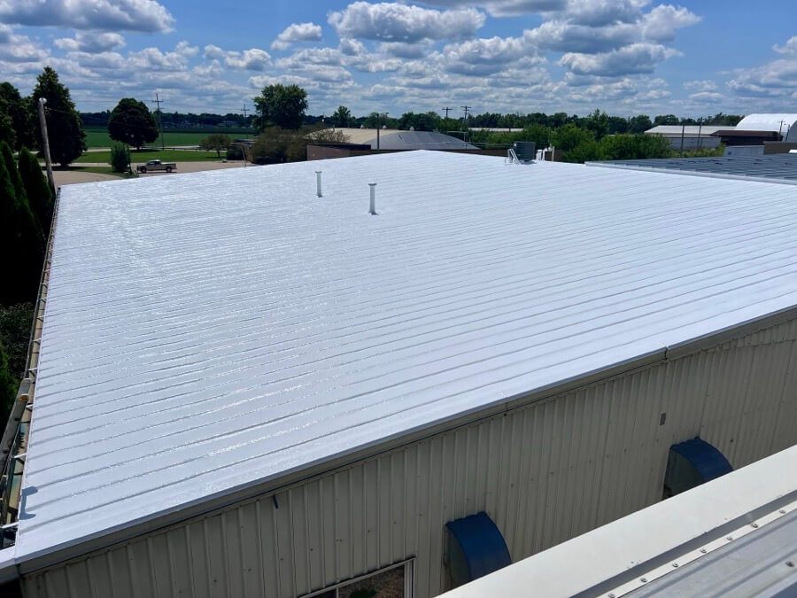 commercial-metal-roof-restoration-reflective-coating-99 commercial metal roof restoration with white reflective roof coating on industrial building