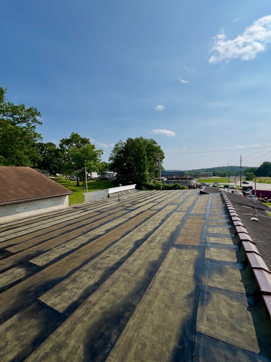 commercial flat roof membrane prepared for replacement showing seams and waterproofing layers