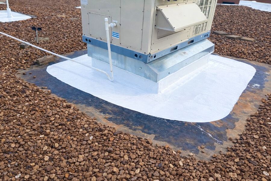 commercial-roof-penetration-flashing-maintenance-99 commercial roof maintenance around HVAC penetration with new flashing and sealant