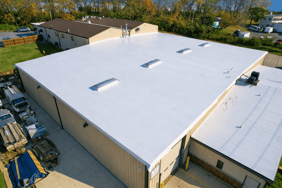 commercial TPO roof replacement installed on large warehouse building with white membrane roofing system