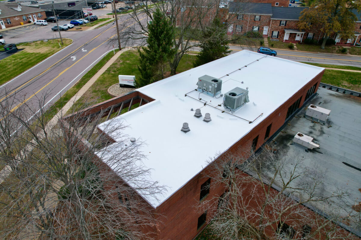 pvc-roof-commercial-building-white-membrane-98 PVC roofing system installed on commercial building with white reflective membrane and rooftop units
