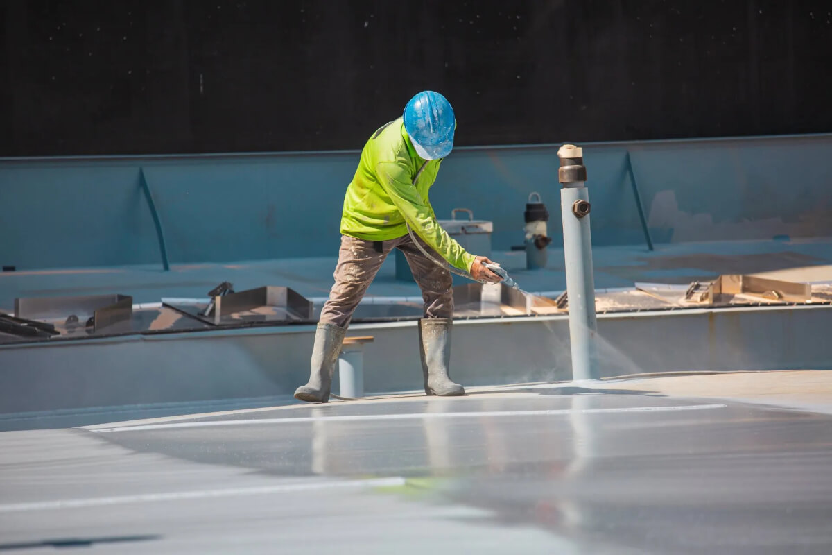 spray-foam-roof-finished-white-coating-98 Finished spray foam roofing system with white protective coating on commercial building