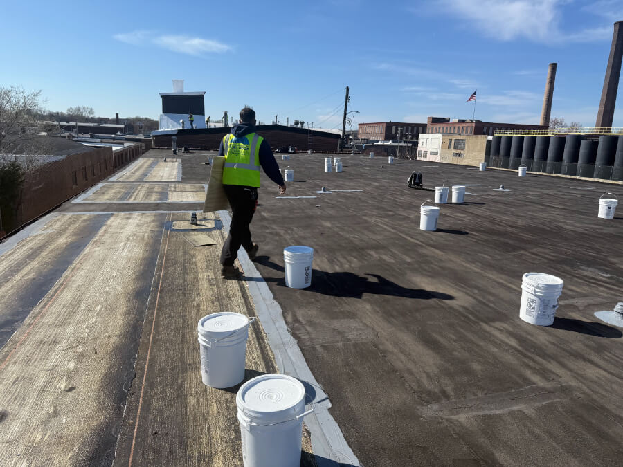 shopping-center-roof-maintenance-99 Commercial roof maintenance being performed on a shopping center flat roof