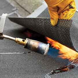 img-card-modified-bitumen A contractor installs TPO flat roofing during commercial flat roof restoration.