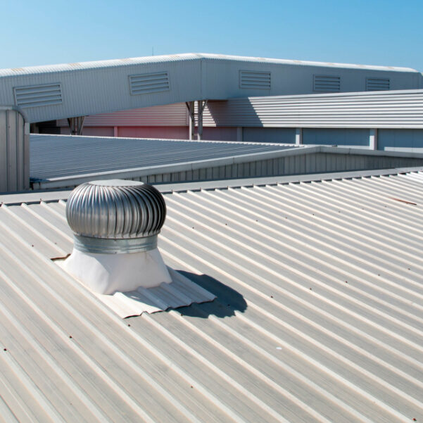 metal-roofing-total-replacement Flat roof with TPO overlay and metal turbine, ideal for commercial roof repair.