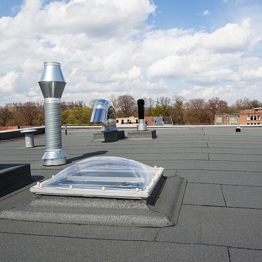roof-overlay Commercial flat roof with TPO membrane, vents, ducts, and skylight—ideal for flat roof restoration and commercial roof repair.